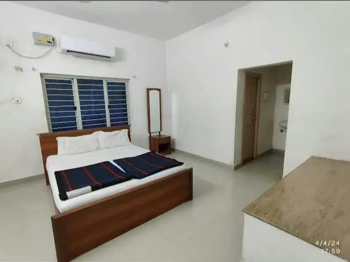 Bright room with wooden double bed, AC and attached bathroom