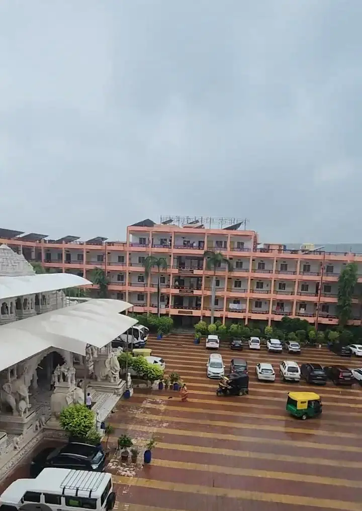 Lodging blocks beside the white marble temple and courtyard parking