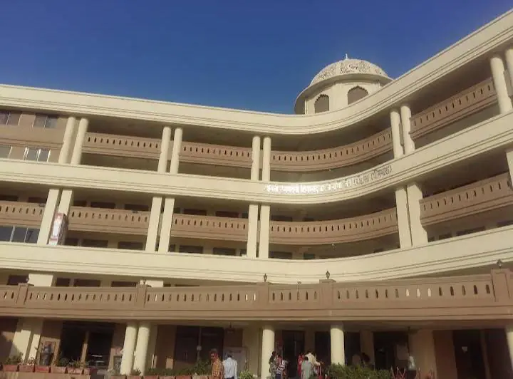 Curved multi-storey building with balconies and a domed top