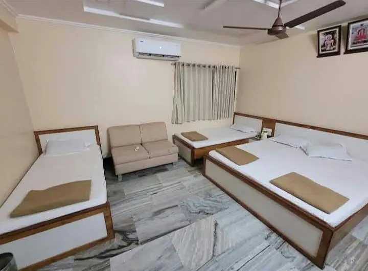 Spacious room with three beds, sofa, AC and marble flooring